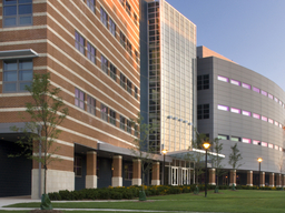 The picture shows three UMBC buildings, and a yard.