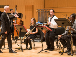A group of musicians performs on stage.