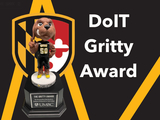 The DoIT Gritty Award Trophy in UMBC colors and shield.
