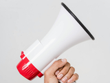 image of a bullhorn held by a hand